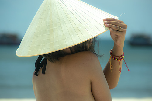 Woman wearing conical hat wearing neutral colored rings Young woman wearing neutral colored Swagmat silicone rings for women